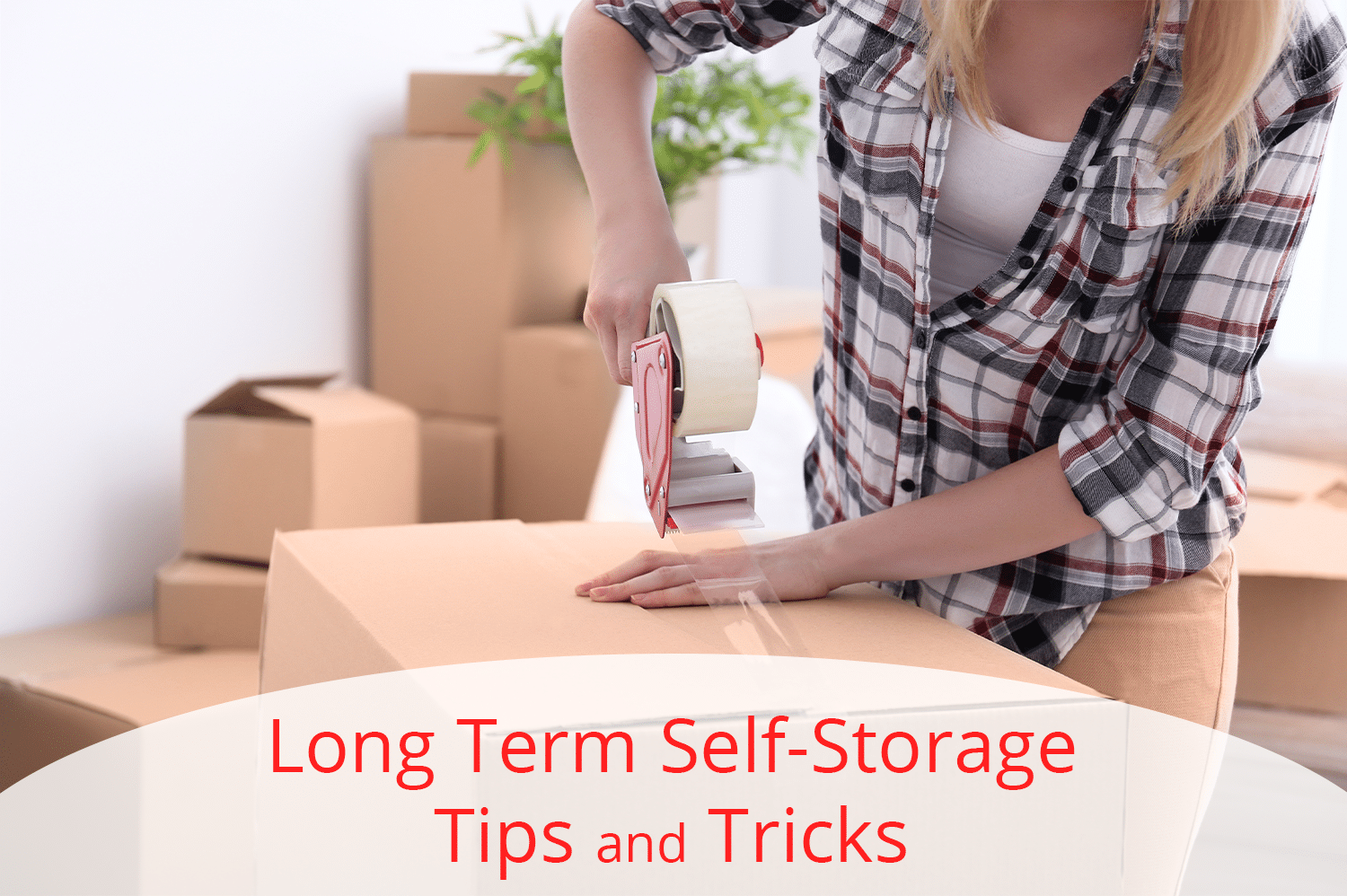 Post Falls woman using our self-storage tips and tricks to pack things away in cardboard box.