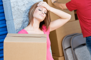 A woman getting stressed because her self-storage unit is too full.