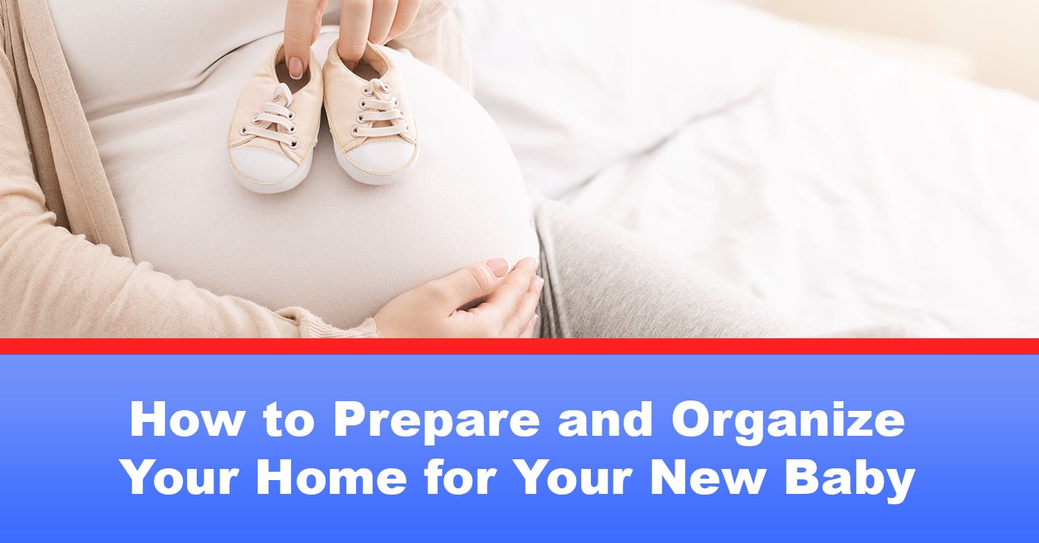 A expecting mom sitting in a chair, holding her belly with one hand and resting baby shoes on top of it in another.