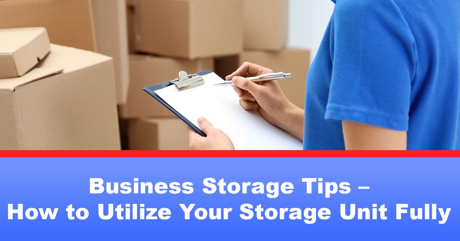 A person checking inventory off a list on a clipboard in their business storage unit.